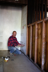 Man removing drywall